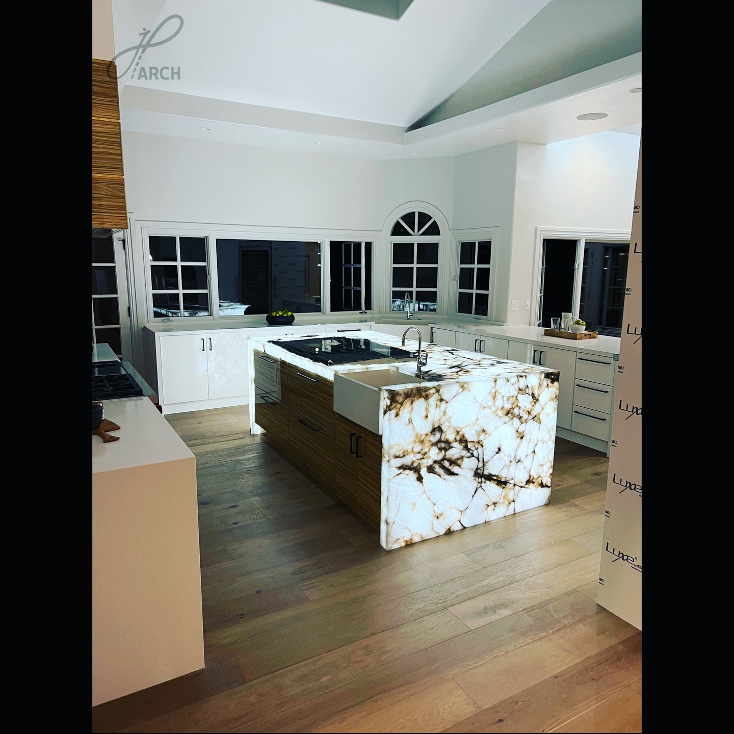 This marbling waterfall island anchors the kitchen with scul